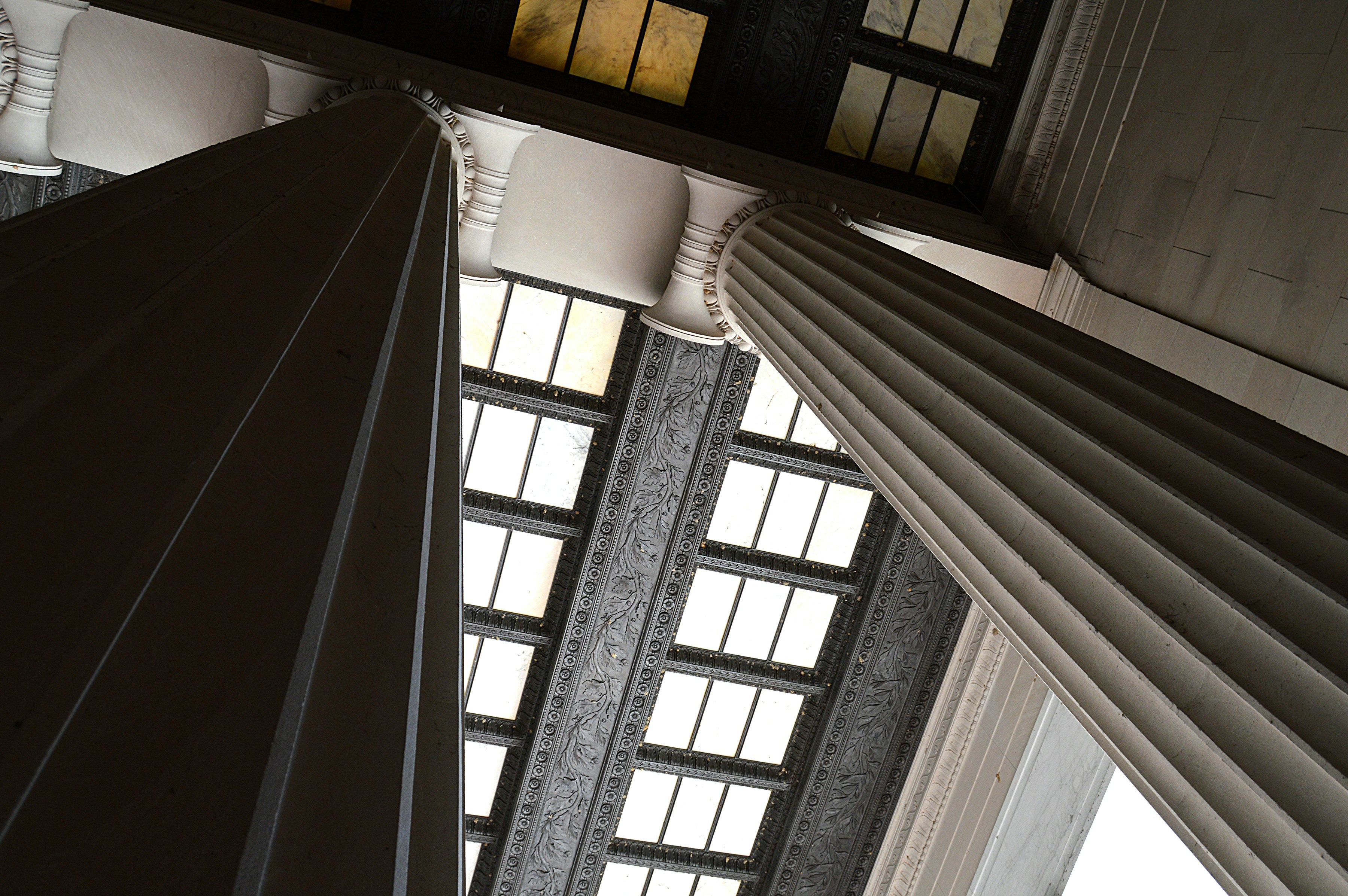 low-angle photography of building pillars